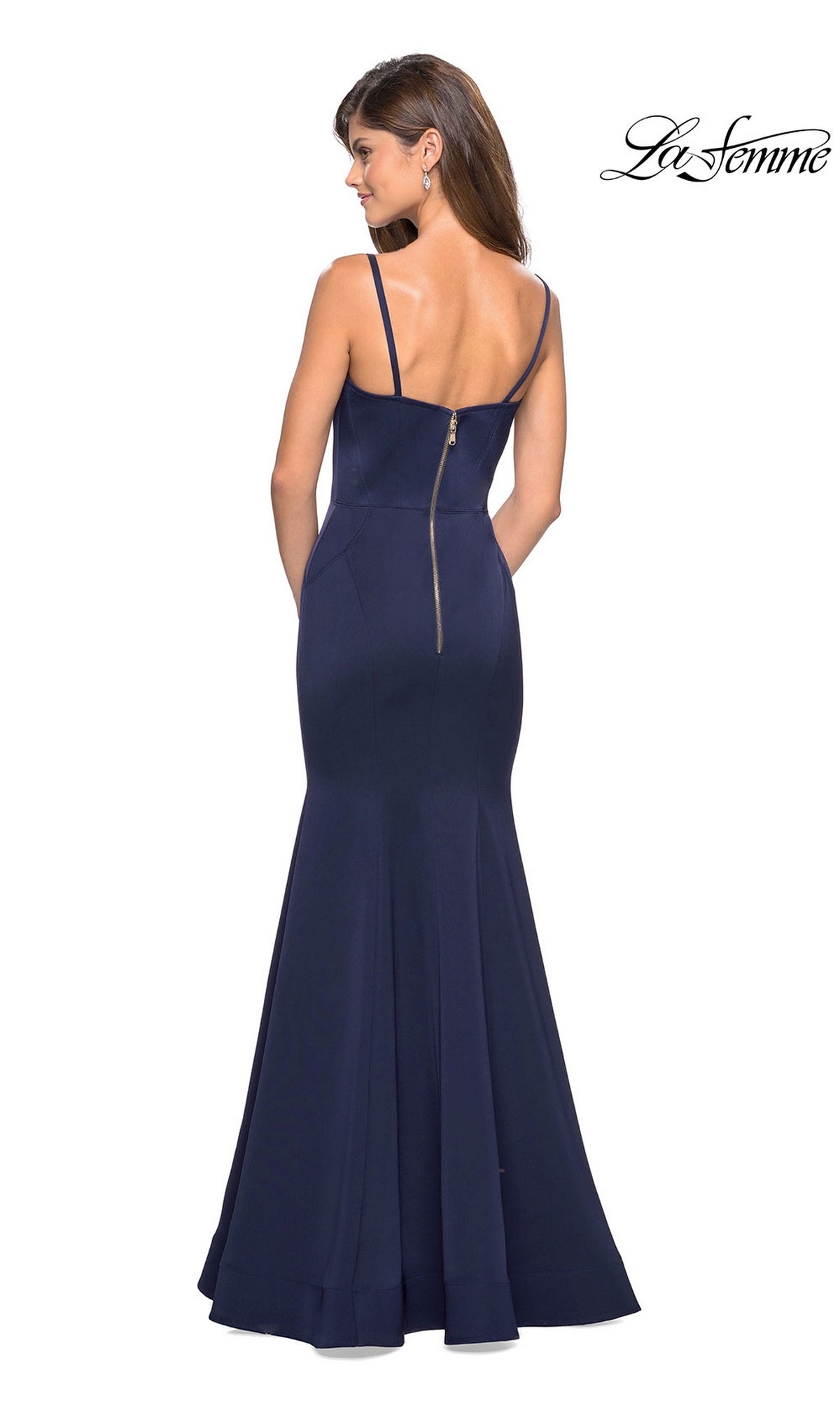 Woman wearing the La Femme Square-Neck Simple Long Prom Dress 27524 in navy blue, featuring a floor-length mermaid skirt, thin straps, and visible back zipper, standing with her back to the camera.